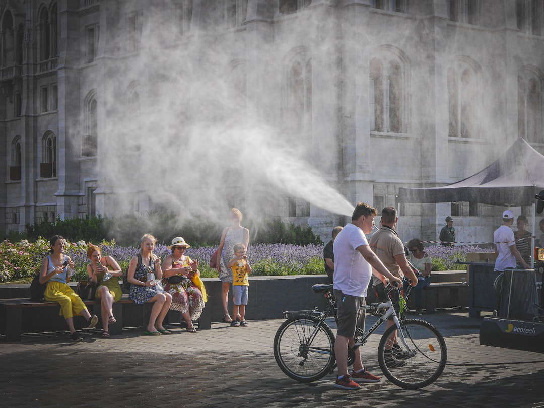 People cooling off from mist spray on a hot day